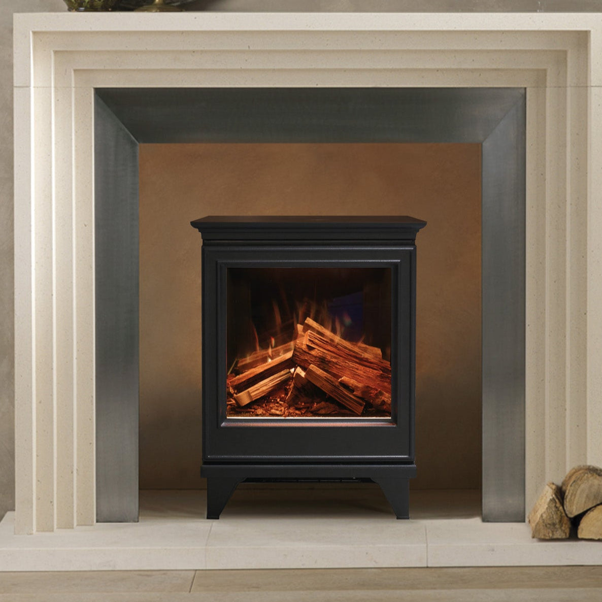 Modern fireplace with a lit fire, white mantel, and decorative elements on a gray wall.