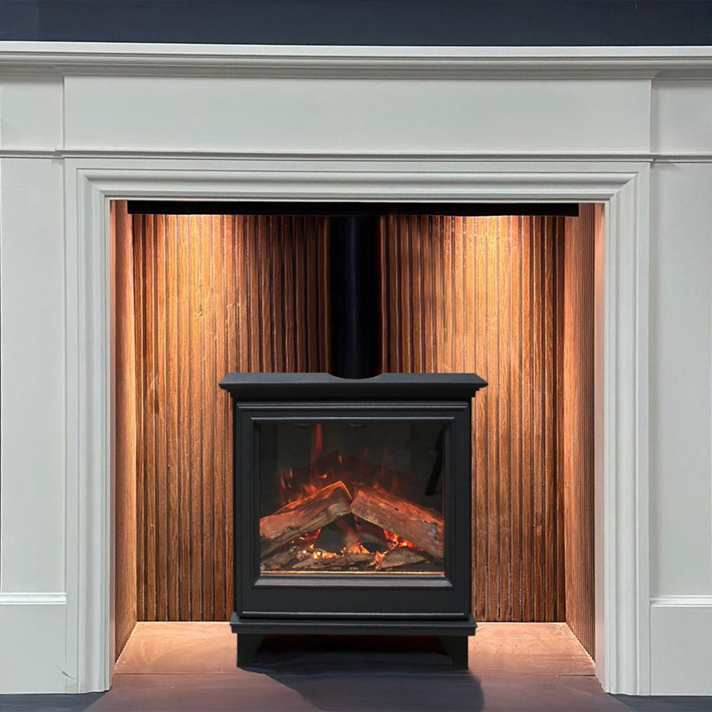 White fireplace mantel with a black electric stove insert and wooden paneling.